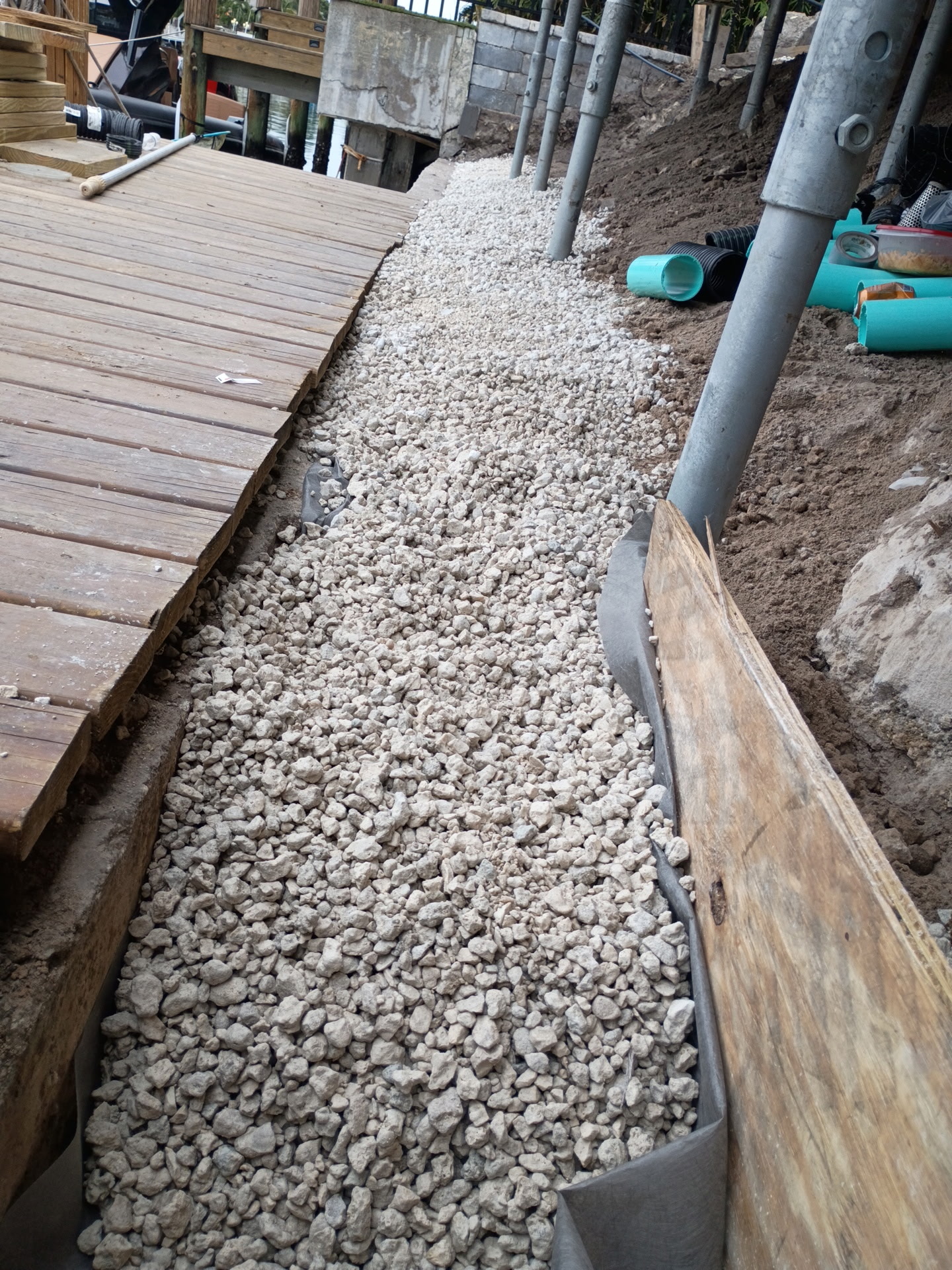 French drain gravel installation for seawall drainage